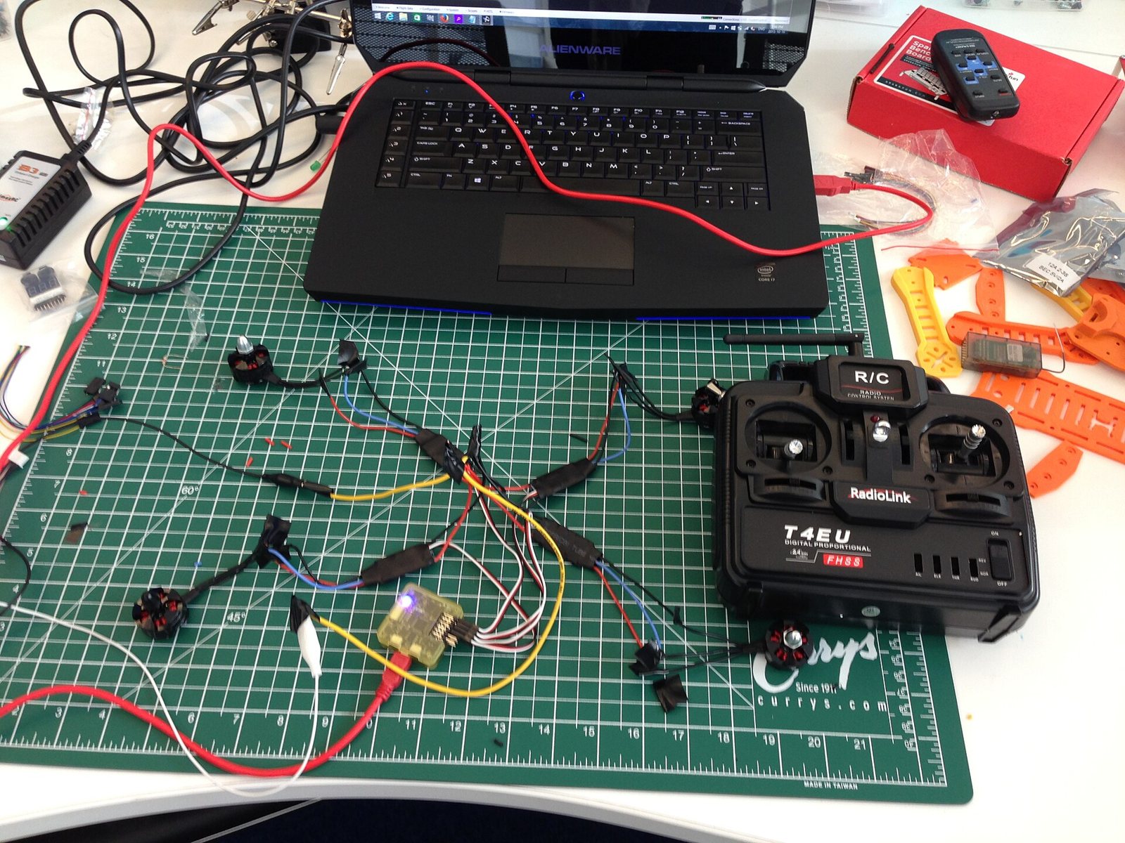Electronics, wiring and radio controller laid out while building a quadcopter