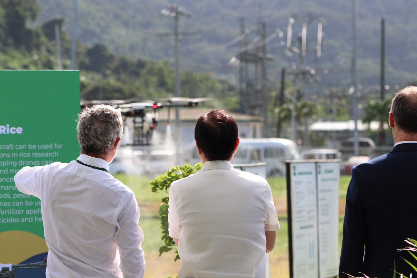 Farmers and researchers watching an agricultural drone demonstration